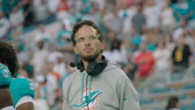 Mike McDaniel, now the Los Angeles Chargers offensive coordinator, wearing a headset on the sideline during his time as head coach of the Miami Dolphins