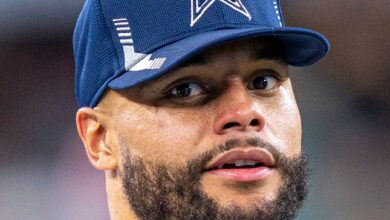 Dak Prescott of the Dallas Cowboys wearing a Cowboys cap on the sideline