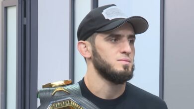 Islam Makhachev holding a UFC championship belt