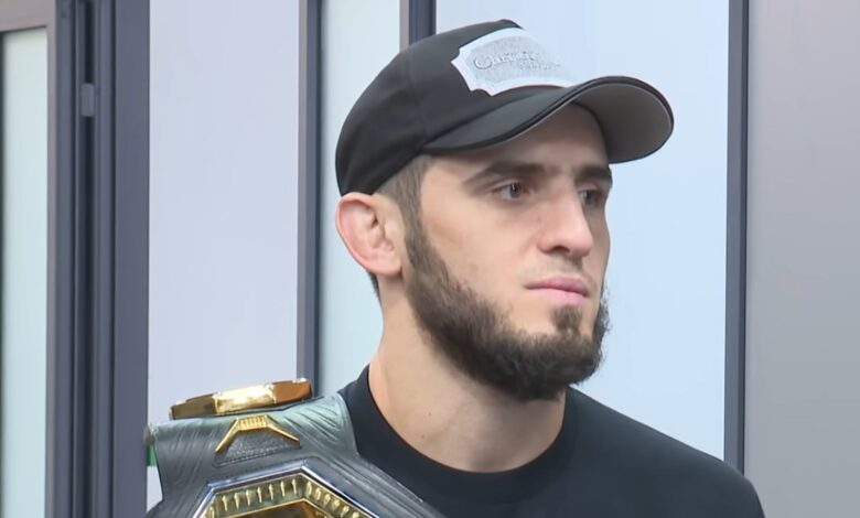 Islam Makhachev holding a UFC championship belt